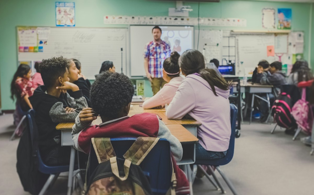 Students seated at desks in a bright classroom