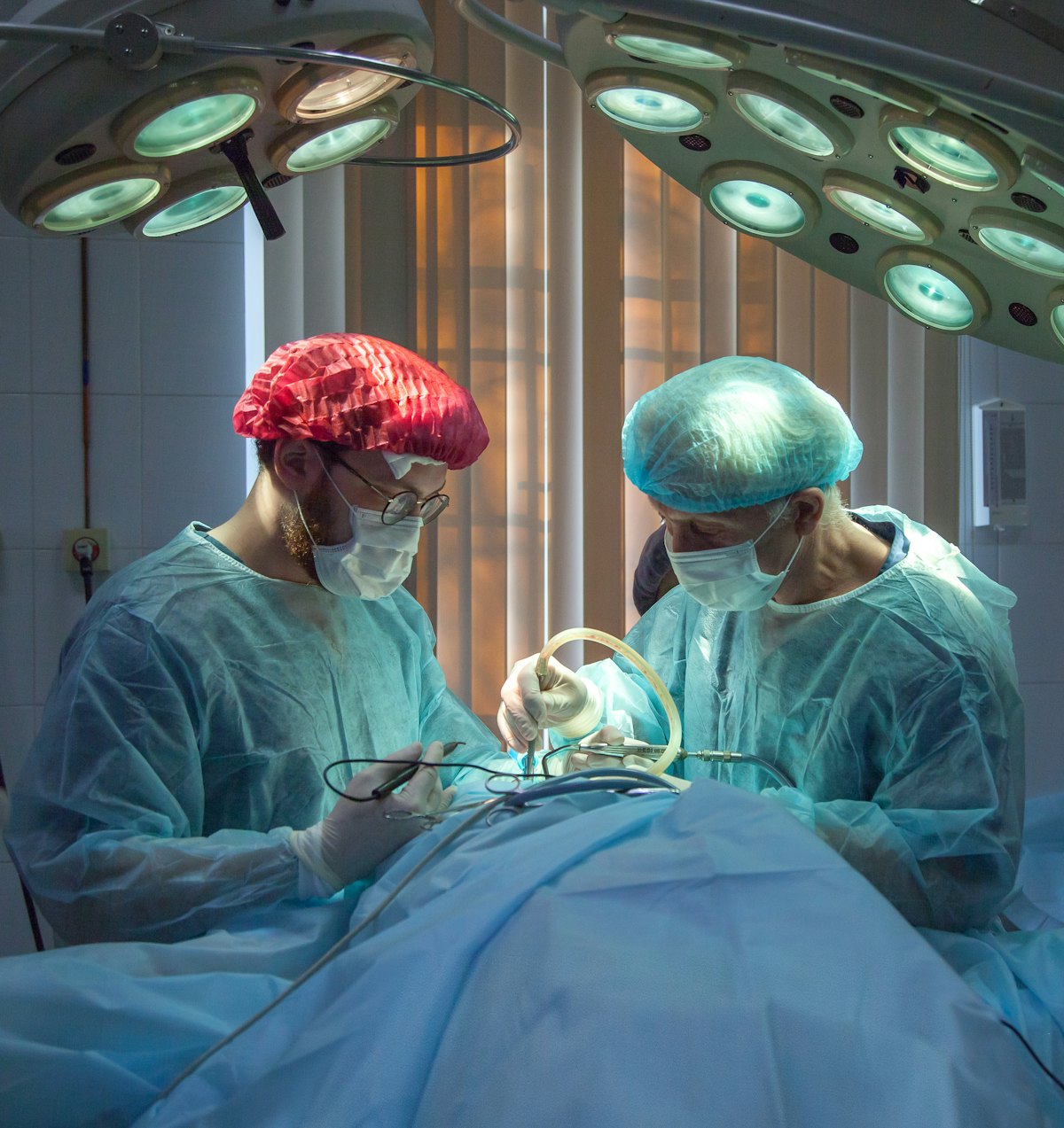 Surgical team working under theatre lights