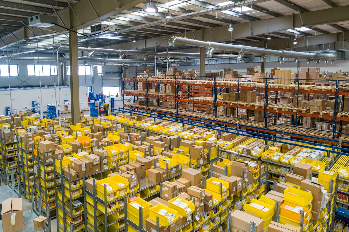 Warehouse racks filled with yellow and brown parcels