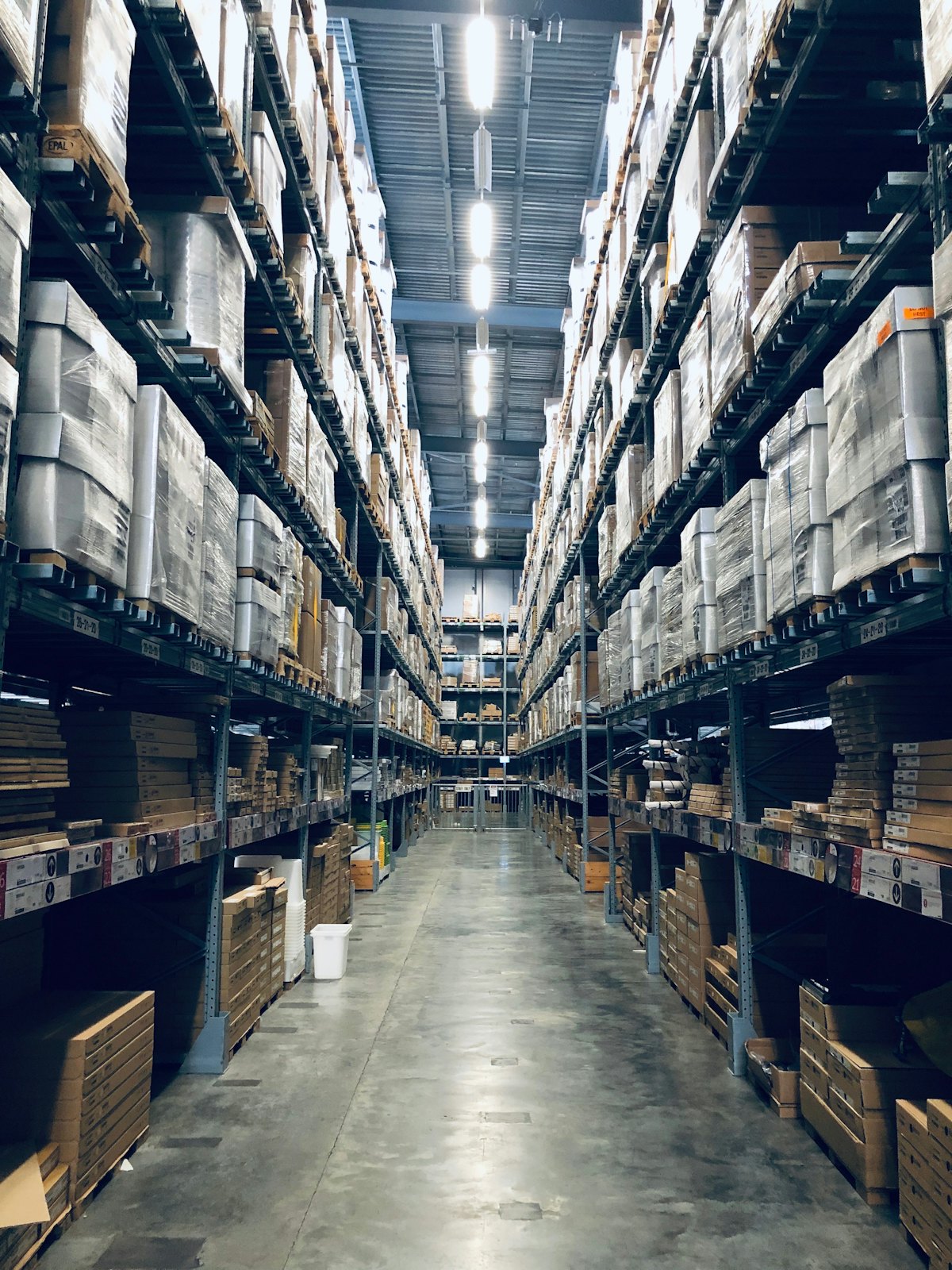 Long aisle between tall shelves stacked with boxes