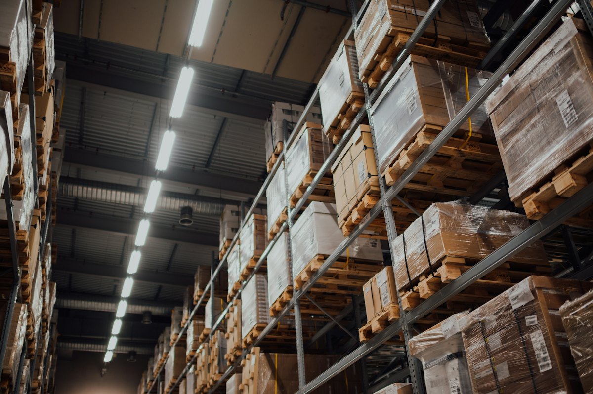 Storage shelves holding cardboard boxes under bright lights