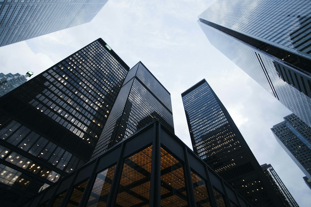 Office towers photographed from below against the sky