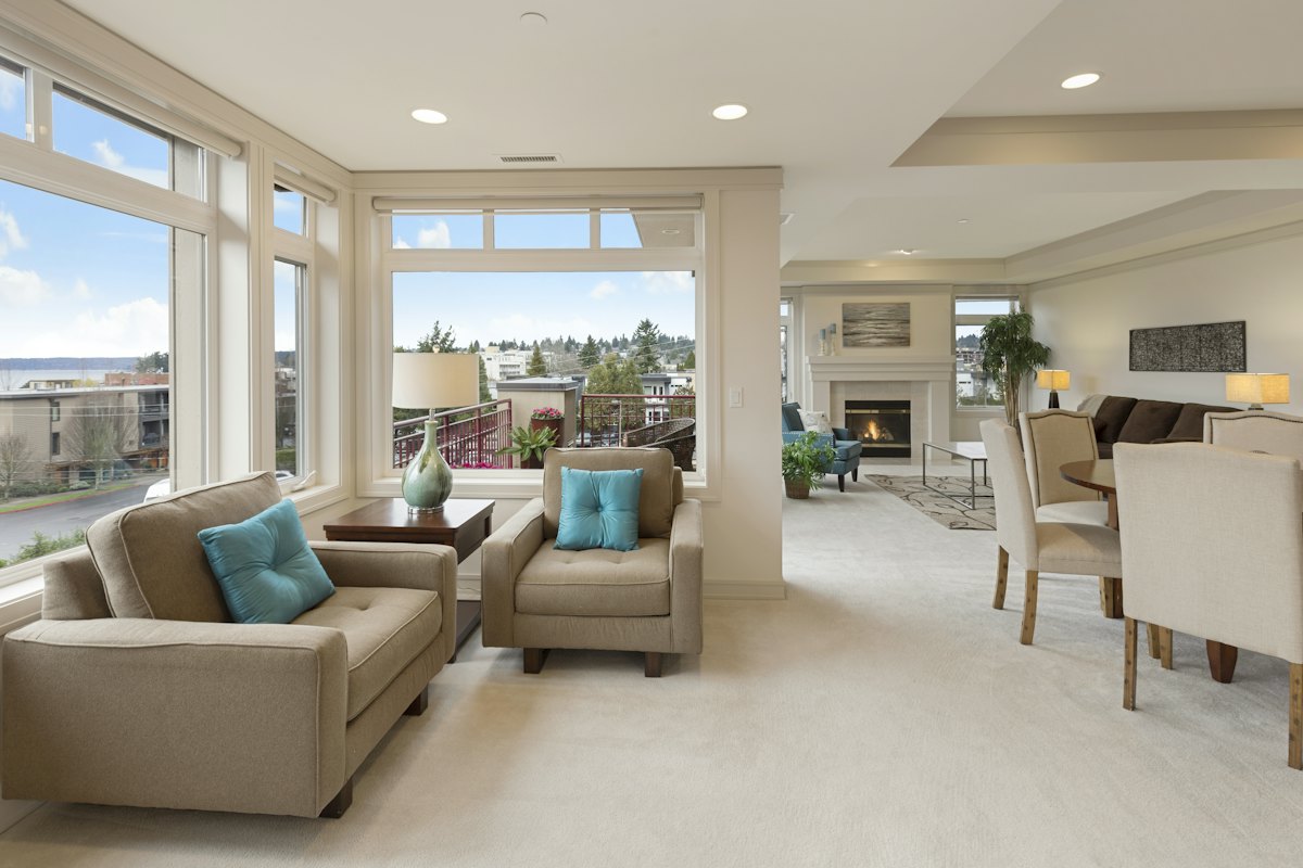 Bright living room with sofas and large windows